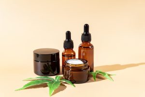 Cannabis face cream, serum or oil dropper concept. Natural cosmetic. CBD oil, THC tincture and hemp